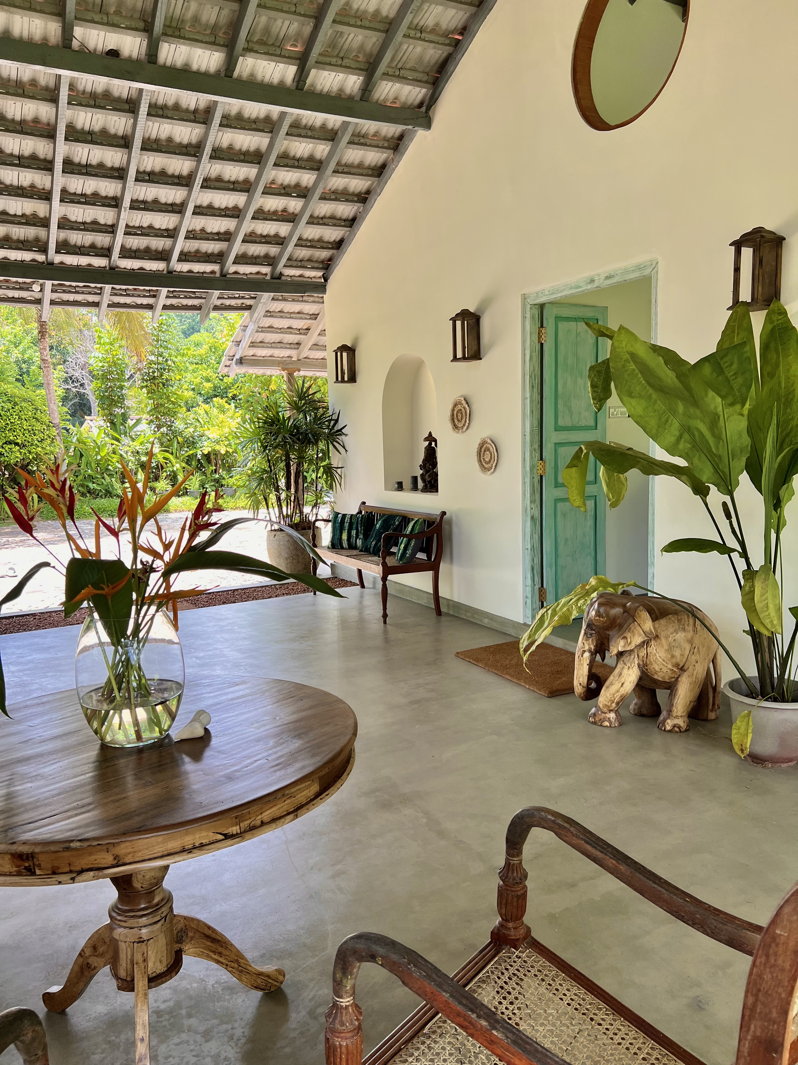 Open veranda with antique chest and garden view